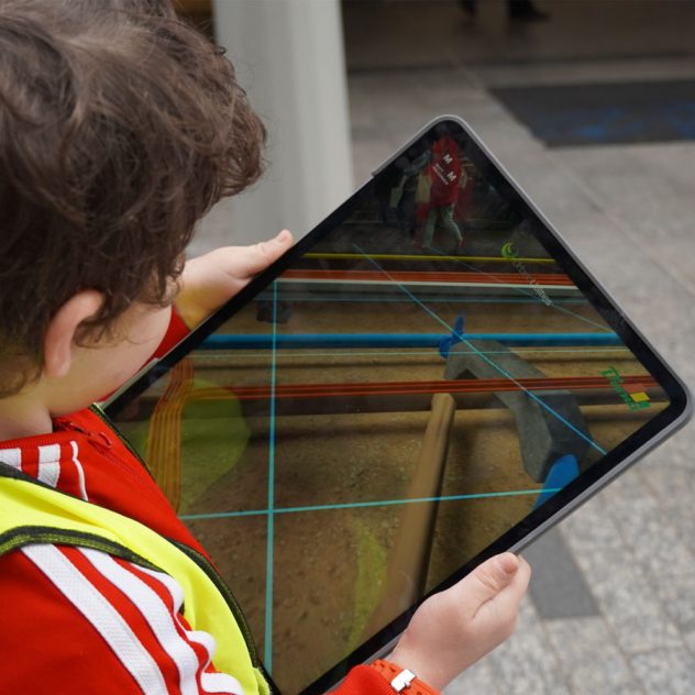 Child experiencing Brisbane's underground water network using the DionAR augmented reality app.