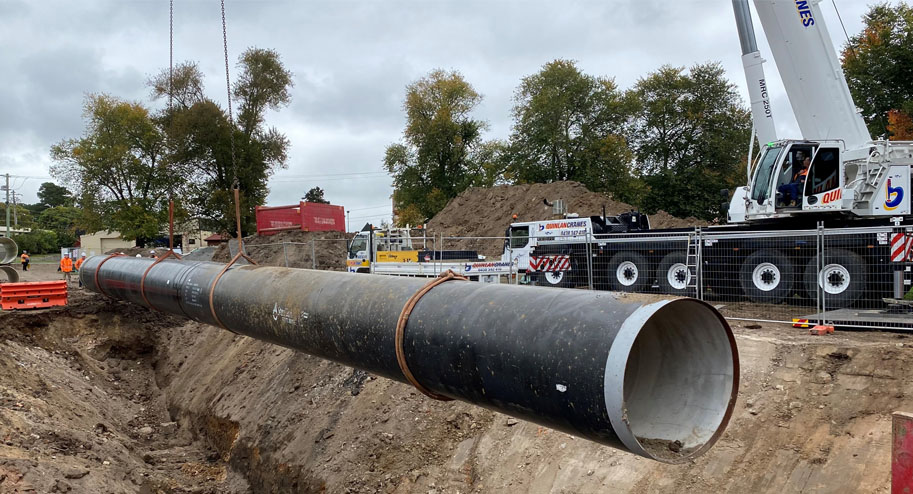 large pipe being carefully lowered into place on the construction site of Ballarat Sewer Build.