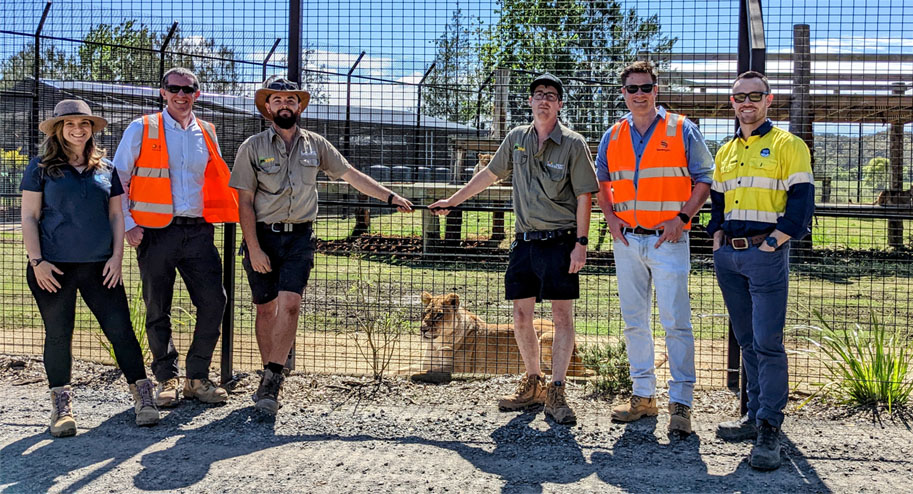 Zoo members and project team standing outside an enclosure at Central Coast Zoo, showcasing their partnership in environmental conservation.
